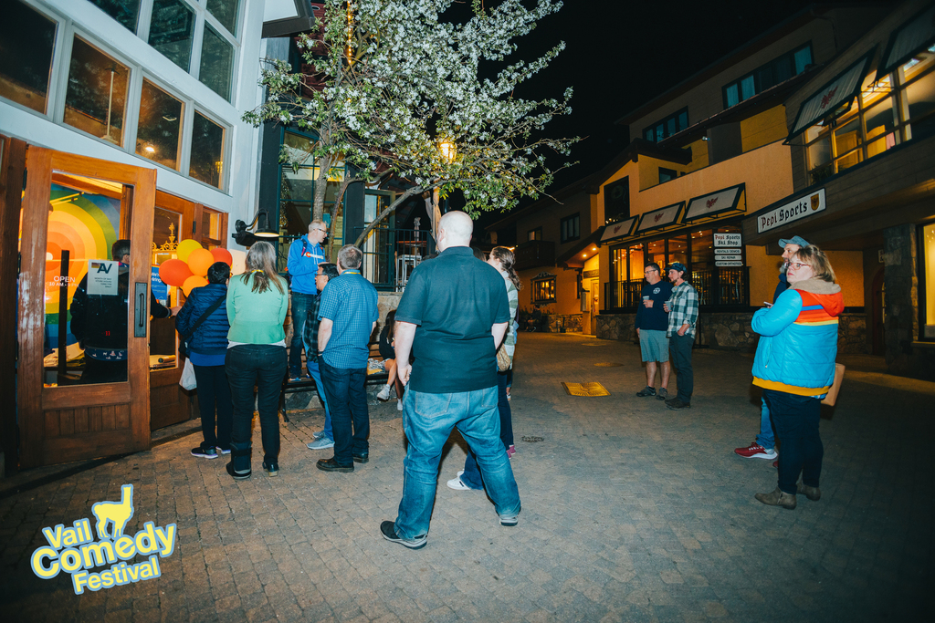 Audience members wait to be let into a pop-up comedy venue as announcements are made at the 2022 Vail Comedy Festival