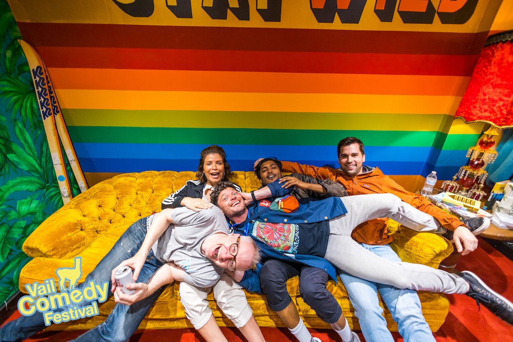 Comics enjoy the hang at the 2022 Vail Comedy Festival and pose for a couch picture in an oversized green room before and after performances