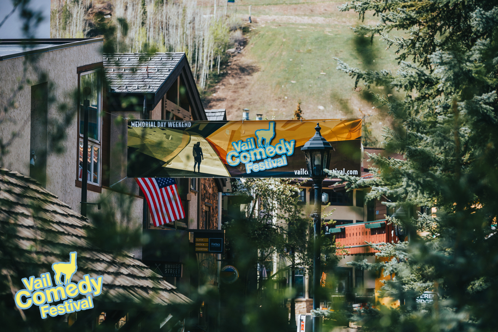 2023 Vail Comedy Festival - Signs, signs, everywhere are signs.  Another beautiful day for this festival banner by the iconic covered bridge in Vail